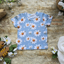 Load image into Gallery viewer, Daisy Chain Kids T Shirts, short sleeve, with a light blue background and a playful white daisy pattern, perfect for adding a touch of floral charm to a child's wardrobe.