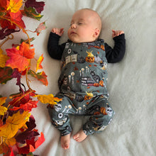 Load image into Gallery viewer, Baby Sleeping with a Smokey Green Halloween Unisex Romper. Potions, Black Cat, Books and Pumpkins over this witchy print. Baby Halloween Clothes