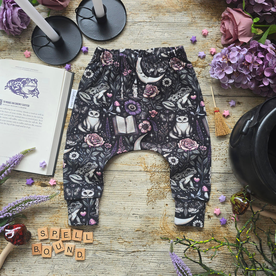 Baby Harem pants with witch-themed pattern with Pink & Purple flowers, books and frogs. Handmade Baby & Toddler Halloween Clothes